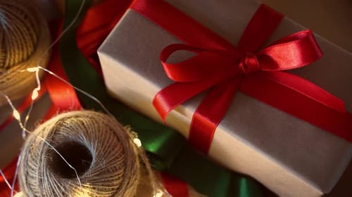 Gift with Red Ribbon and Festive Lights