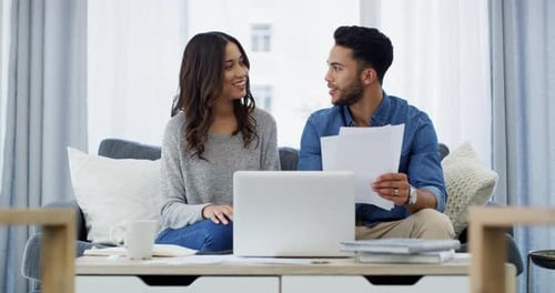 Happy Couple Reviewing Documents Together At Home