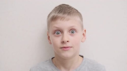 Boy Staring Wide Eyed at Camera in Close Up
