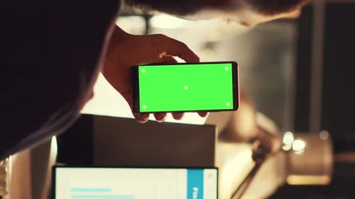 Adult Holding Chroma Key Smartphone in Office