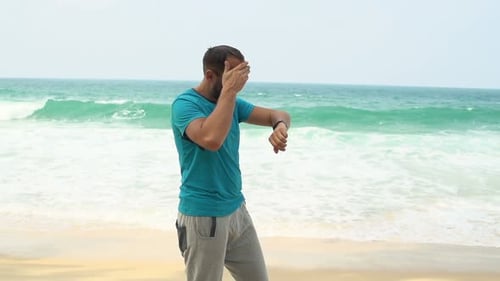 Man Checking Pulse on Smartwatch on Beach After Jogging Super