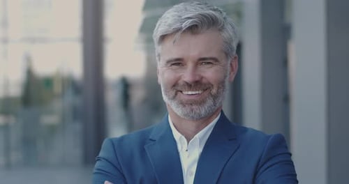Smiling Businessman with Gray Hair in Blue Suit