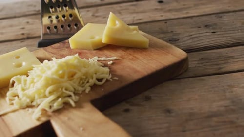 Cheese and Grated Cheese on a Cutting Board
