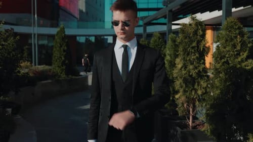 Adult Wearing Suit Looking At Watch Outdoors
