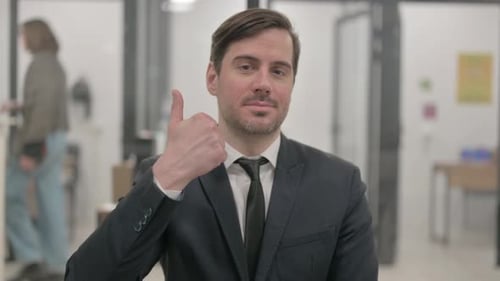 Adult Man Gives a Thumbs Up in Office