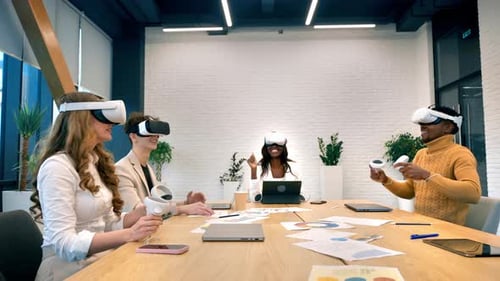 Business conference in VR in an office. Multiracial group of people using VR glasses and controllers