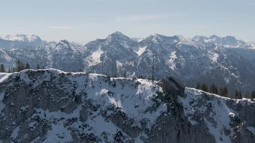 Aerial Drone Shot showing the peak of the Mountain Rauschberg flying a small circle over a Hut on