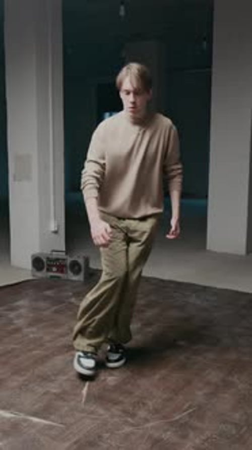 Young Adult Dances in Empty Urban Room