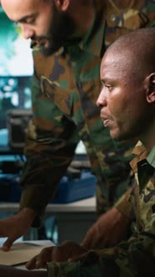 Men in Military Camouflage Reviewing Paperwork