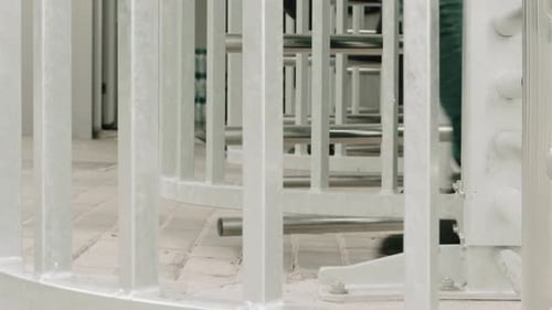 People walking through a revolving gates. Spinning door. Security. Commute.