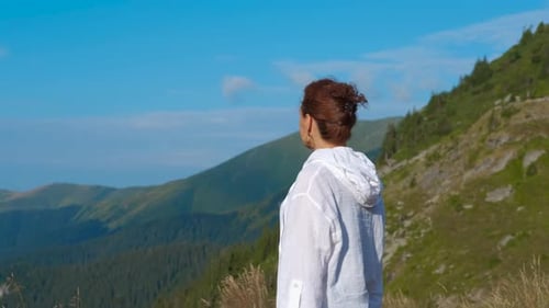 Woman Enjoys Mountain View on Sunny Day
