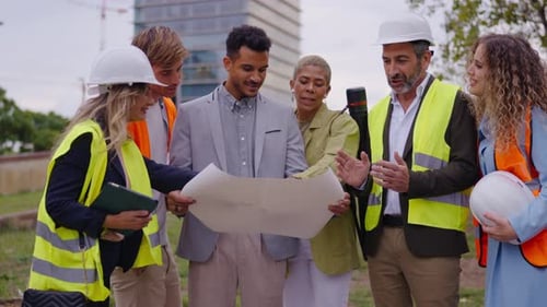 Team of Engineers and Architects Discussing Building Blueprint
