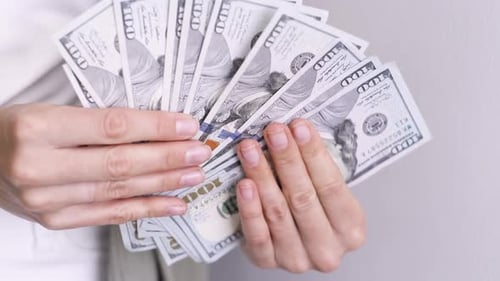 Showing Cash Money 1000 American Dollars Banknotes Close Up in Woman Hands Income Winner and