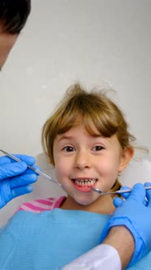 Child Patient Receiving Dental Checkup in Bright Office