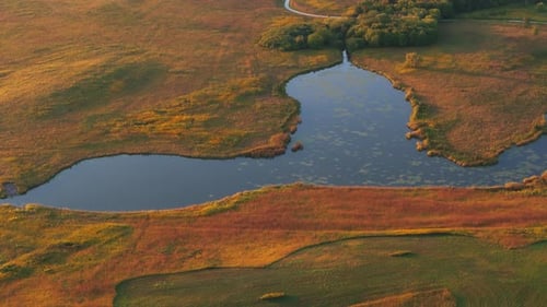Aerial Above Shot of Lake in a Rural Area Suburbs at Sunset
