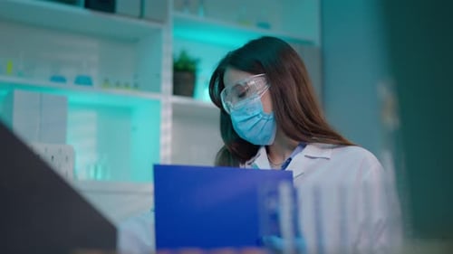Asian female scientist working in the biotechnology research laboratory.