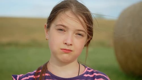 Cheerful Girl Eating Potato Chips During Family Picnic at Field Joyful Female Snacking on Crispy