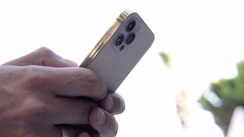 Hands Holding a Modern Smartphone Device