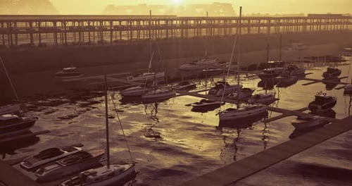 Sunset Casts Golden Glow Over Marina with Boats and Quiet Waters