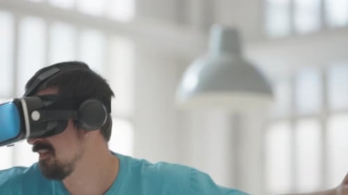 Excited Man Experiencing Virtual Reality at Home