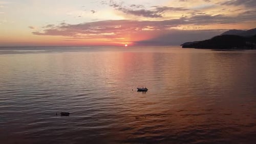 Aerial sunset on the sea, breathtaking view of the sun setting over the ocean