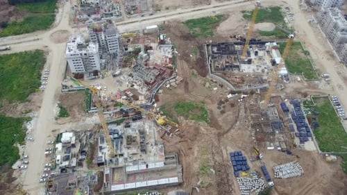 Large residential construction site with cranes, Aerial view