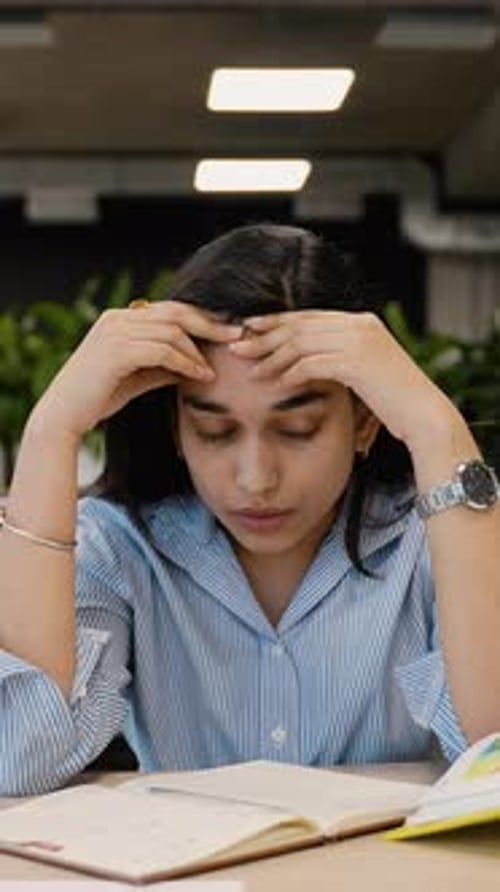 Stressed Indian Student Experiencing Headache While Studying