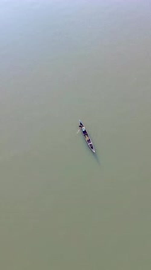 Aerial View of a Boat on a Calm River