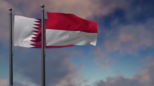 Qatar and Indonesia National Flags Waving Against Blue Sky