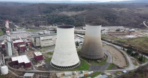 Aerial orbiting in circle around Santa Barbara power station. Cloudy day, Winter season. Cavriglia,