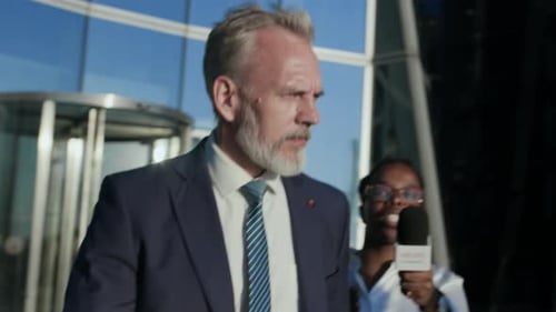 Businessman Giving Statement to Press Interview