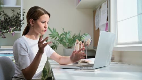 Woman Engaged in Video Call in Home Office