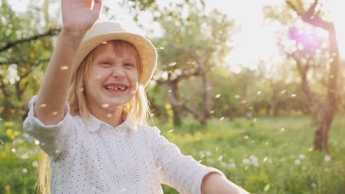 Happy Child Playing with Bubbles in Summer Orchard