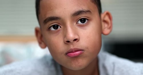 Hispanic little boy child portrait, no expression serious emotion