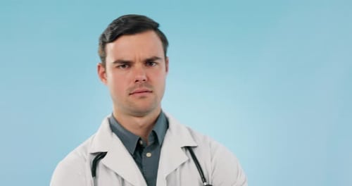 Healthcare, thinking or confused with a doctor man on a blue background in studio for diagnosis