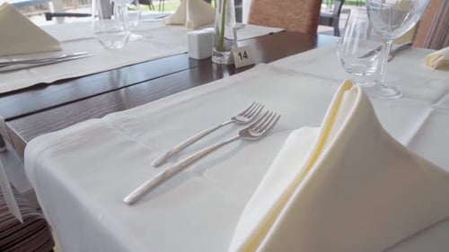 Elegant Restaurant Table Setting with Silverware and Glassware