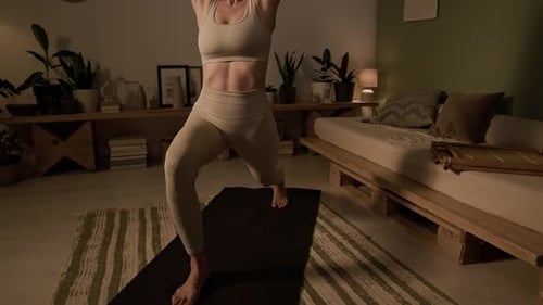 Woman Practicing Yoga at Home at Night