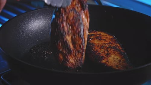 Flipping Chicken Breast Cooking In A Pan. Preparing Honey Soy Chicken Dish. close up
