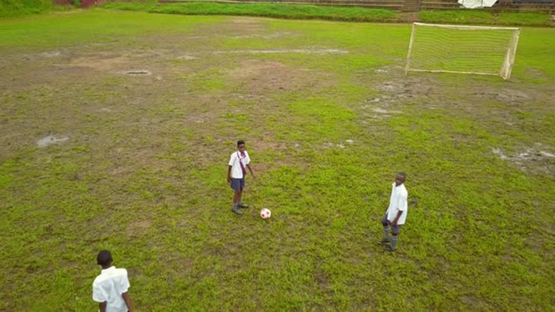 African Boys In School Uniform Playing Football On Daytime In Uganda ...