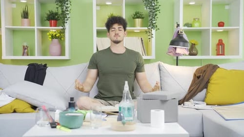 Man Meditating Comfortably on a Sofa at Home