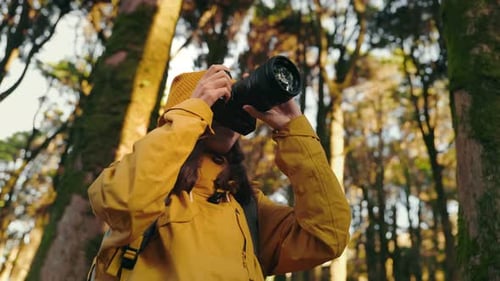 Happy Woman Taking Photos in Forest