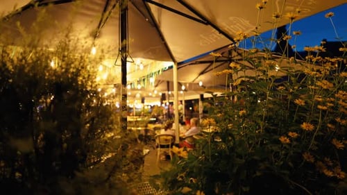 The Charming Outdoor Restaurant Offers a Delightful Ambience with Beautifully Lit Canopies in the