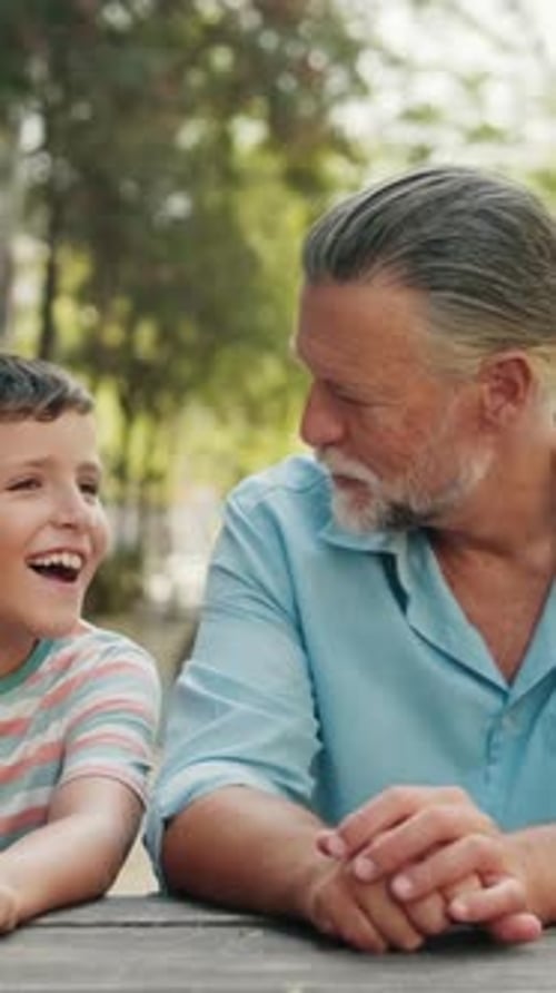 Vertical video, Grandfather and Grandson Enjoy a Day at the Park
