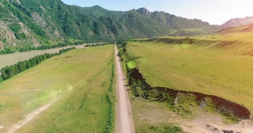 Aerial Rural Mountain Road and Meadow at Sunny Summer Morning Asphalt Highway and River
