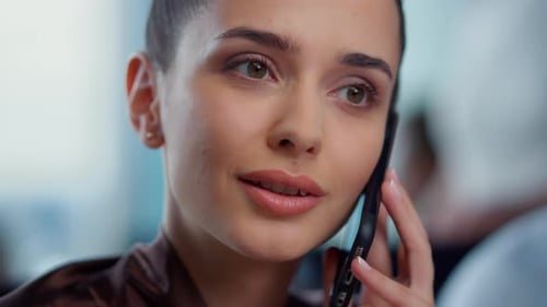 Young Woman Talking on Cell Phone in Office