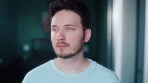 Man Breathing Deeply and Closing Eyes By Window