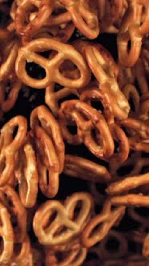 Salty Pretzels Fly and Fall on a Black Background Filmed on a Highspeed Camera at 1000 Fps