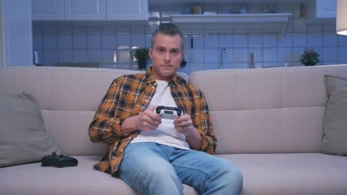 Man Playing Video Games on a Couch