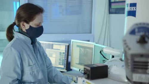 Woman Scientist Works with High Tech Equipment
