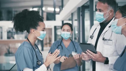 Medical Team Discussing Patient Care in Hospital